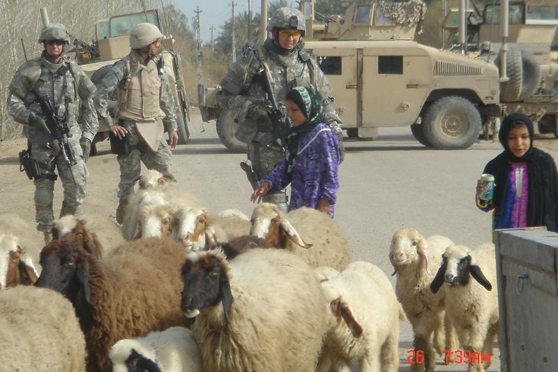 Then-Major Spivey on combat patrol meeting young girls driving sheep near Salman Pak, Iraq, March 2006